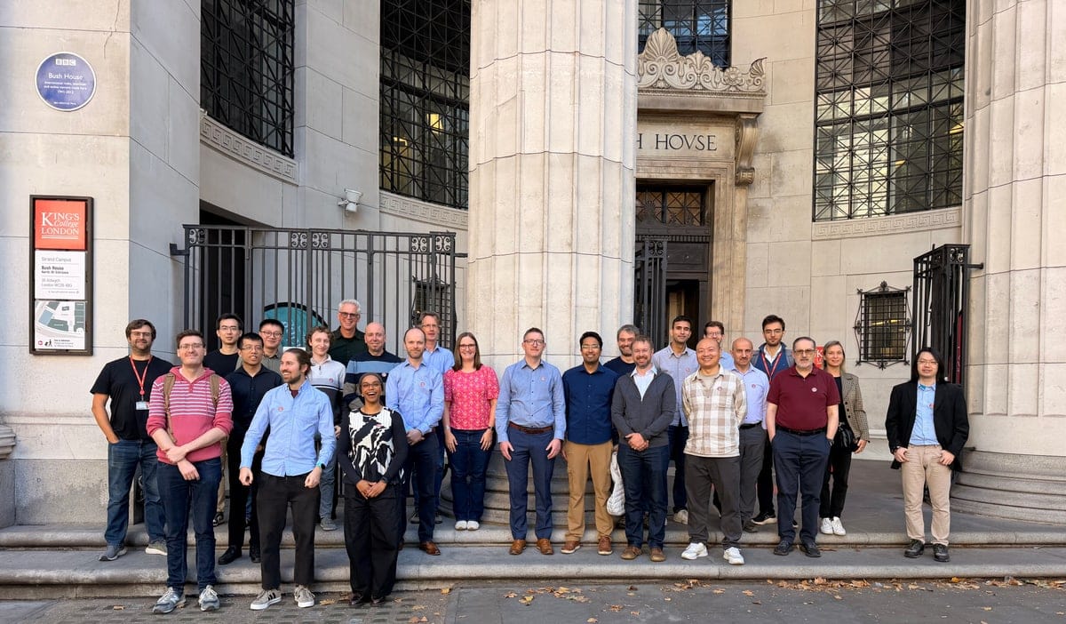 The REMODEL consortium standing together on the steps outside Bush House at King's College London.